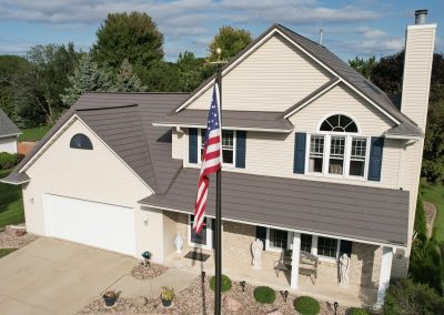 Oxford Metal Roof on a Tan House with an American Flag on a Flag Pole